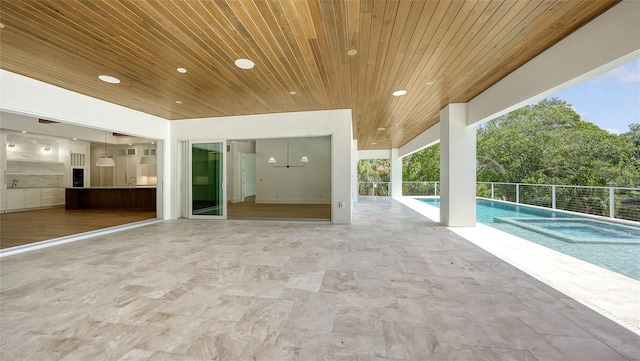 view of patio / terrace with a fenced in pool