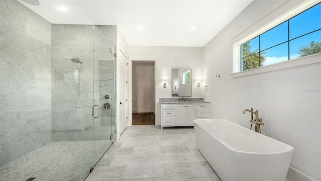 bathroom with vanity and separate shower and tub