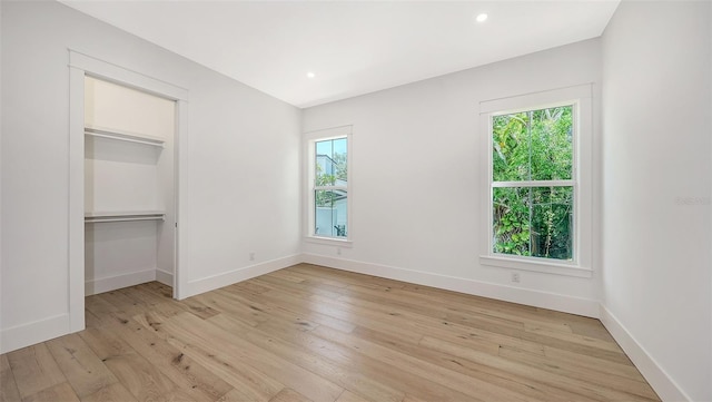 unfurnished bedroom featuring a closet and light wood-type flooring