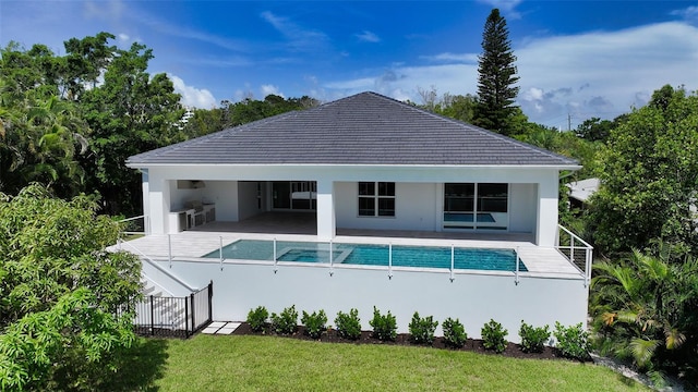 rear view of house featuring a yard and a patio area