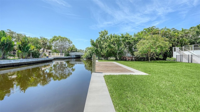 view of property's community featuring a lawn and a water view