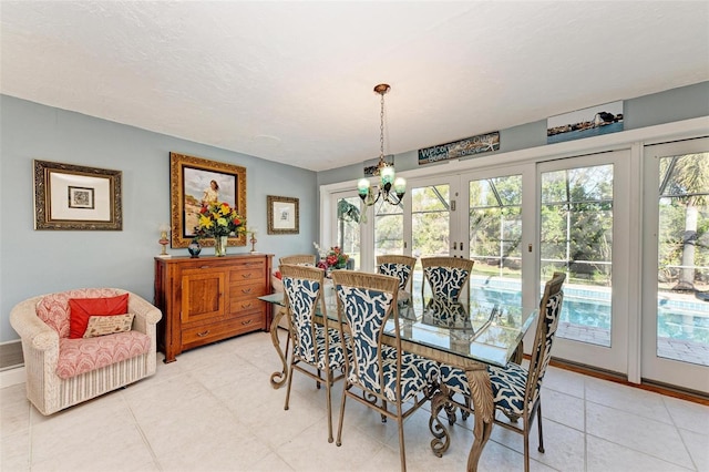 dining space with a chandelier and a textured ceiling