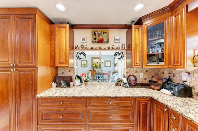 kitchen with backsplash and light stone counters