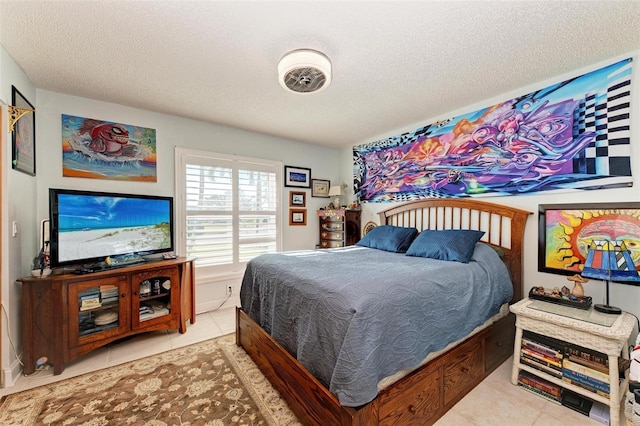 bedroom featuring light tile patterned floors and a textured ceiling