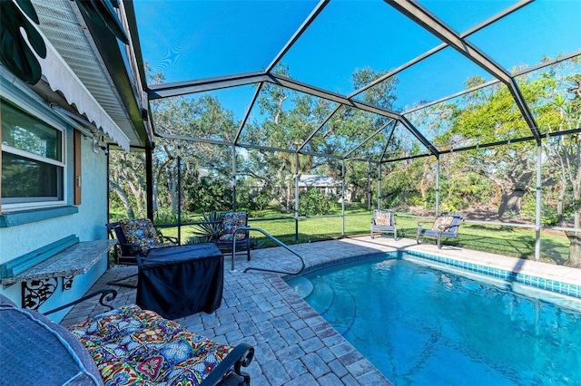 view of pool featuring a yard, a lanai, and a patio area