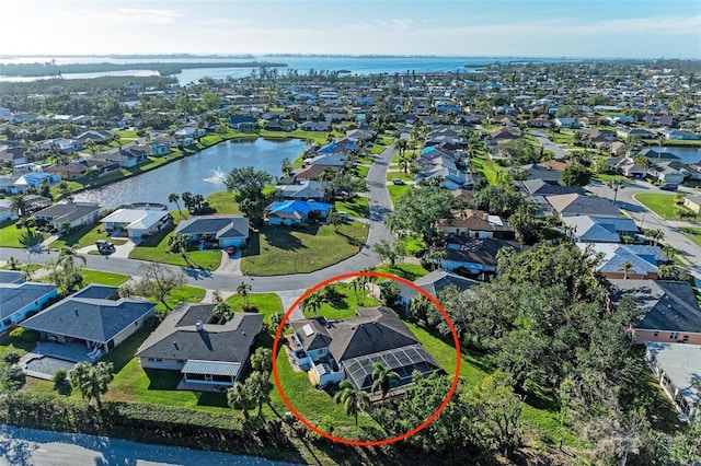 birds eye view of property with a water view