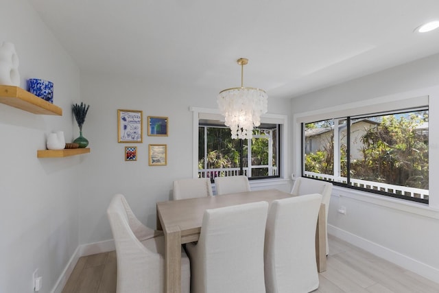 dining space with a chandelier and light wood-type flooring