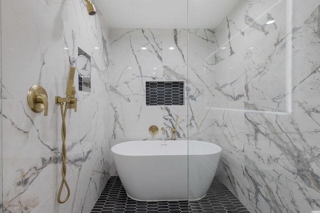 bathroom featuring a bath and tile walls