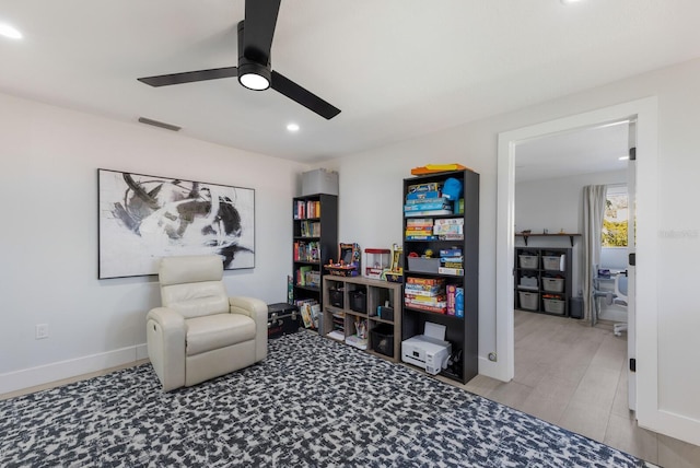 living area with ceiling fan