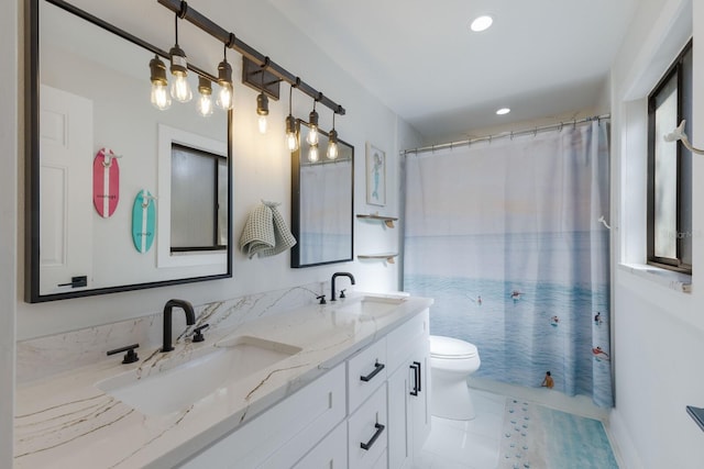 bathroom with tile patterned flooring, vanity, and toilet