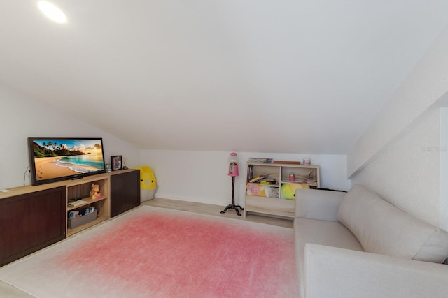 interior space with light carpet and vaulted ceiling