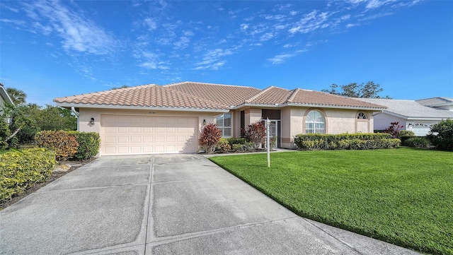 view of front facade with a front yard and a garage