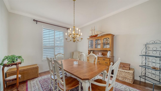 dining space with a notable chandelier, wood-type flooring, and crown molding