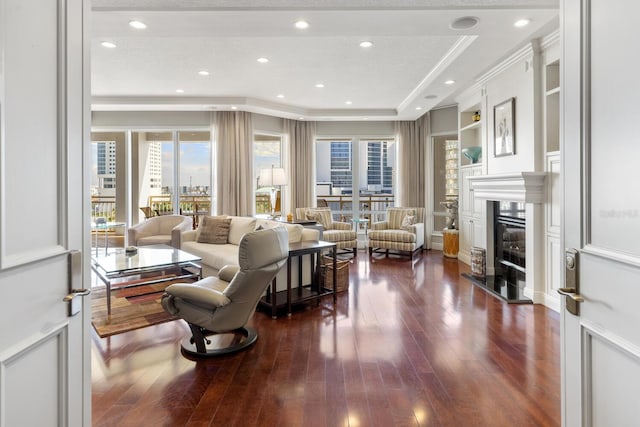 living room featuring dark hardwood / wood-style floors and ornamental molding