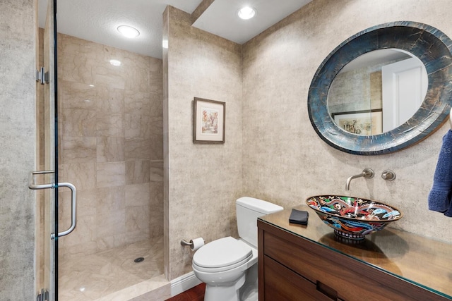 bathroom featuring walk in shower, vanity, and toilet