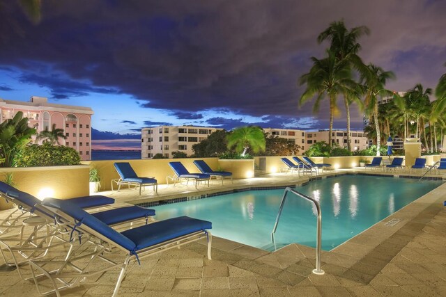 pool at dusk with a patio