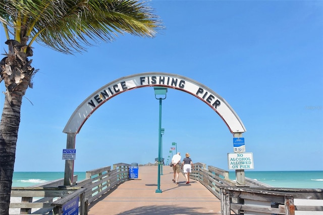 view of property's community featuring a water view and a beach view