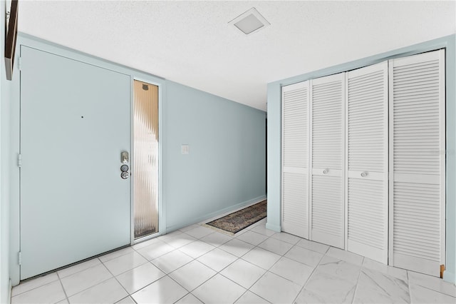 foyer with a textured ceiling