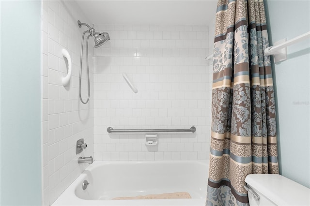 bathroom featuring shower / tub combo and toilet