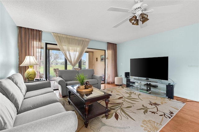 living room featuring hardwood / wood-style floors and ceiling fan