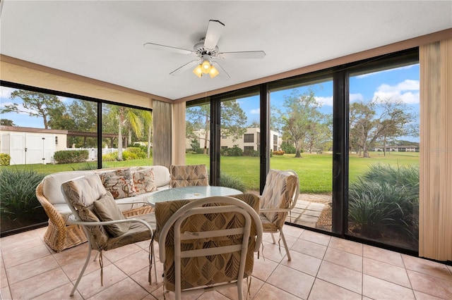 sunroom featuring ceiling fan