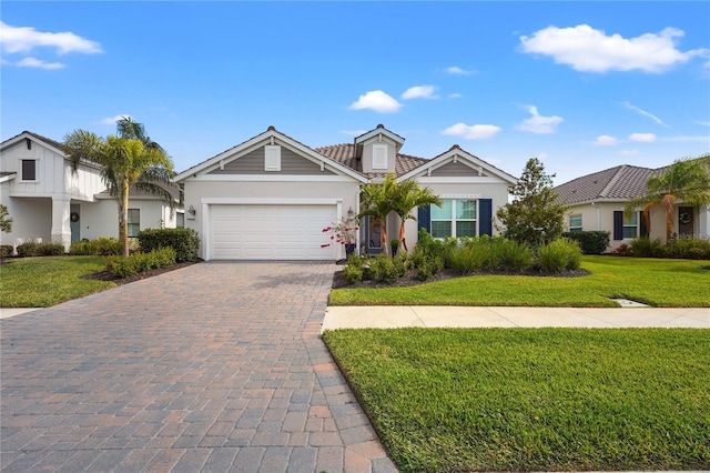 view of front of house with a garage and a front lawn