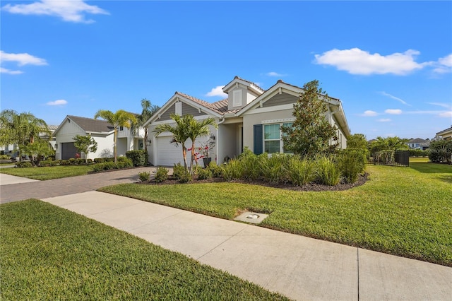 view of front of home with a front yard and a garage