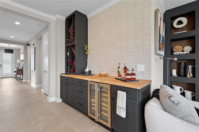 bar featuring light tile patterned flooring, butcher block counters, ornamental molding, and wine cooler