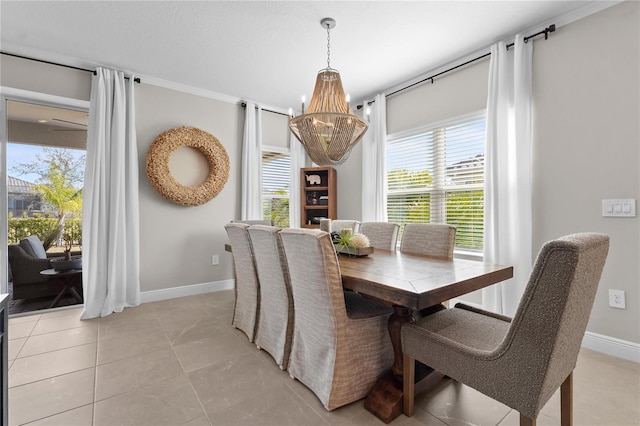 tiled dining room with crown molding and a notable chandelier