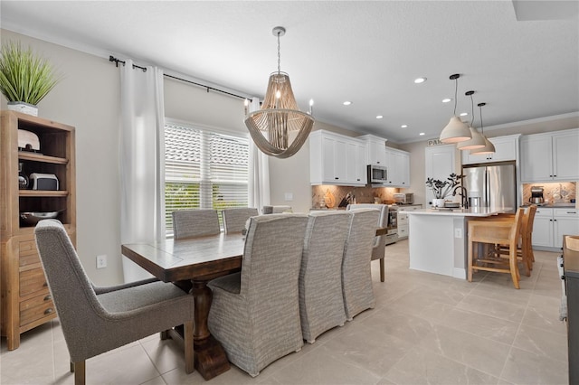 dining area with sink and crown molding