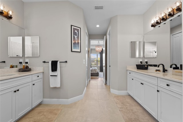 bathroom featuring a chandelier and vanity