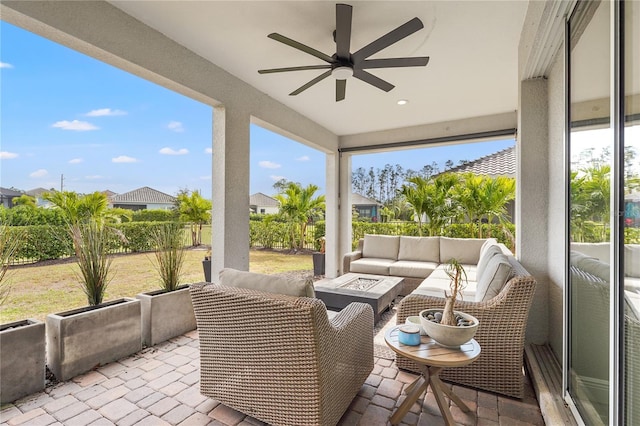 sunroom featuring ceiling fan