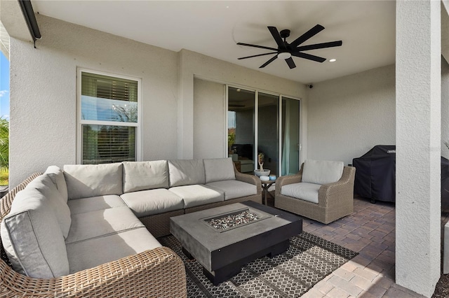 view of patio / terrace with ceiling fan, a grill, and an outdoor living space with a fire pit