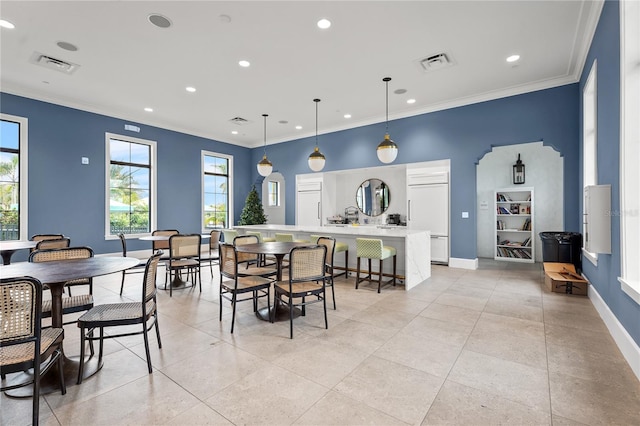 dining room with light tile patterned flooring and ornamental molding