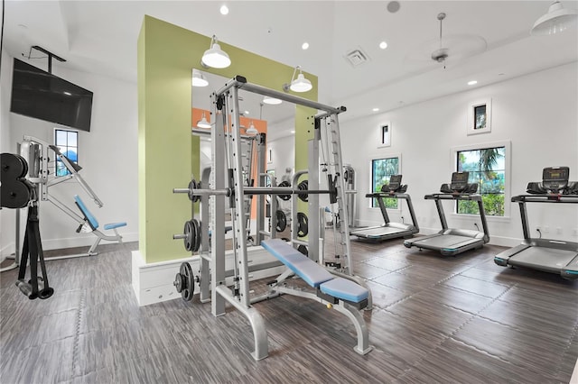 workout area featuring a high ceiling and ceiling fan