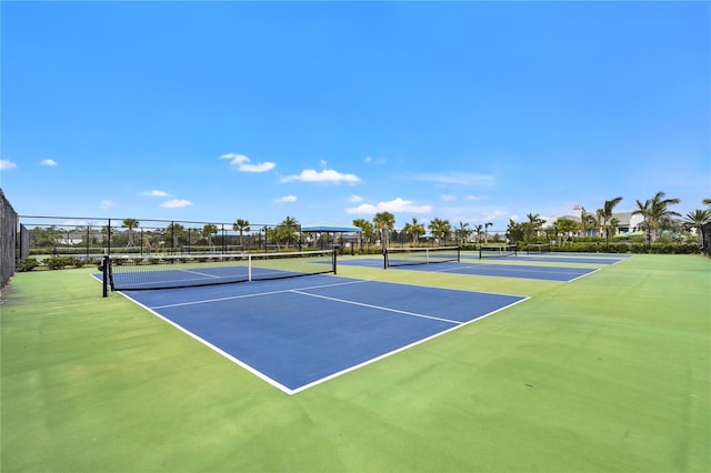 view of tennis court with basketball hoop