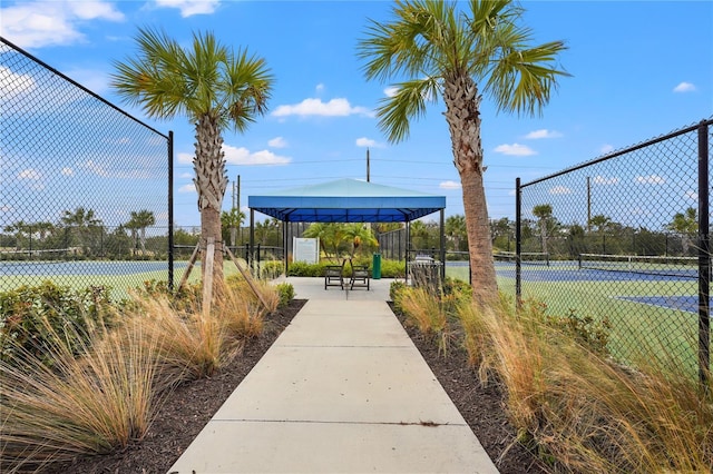 view of property's community with tennis court