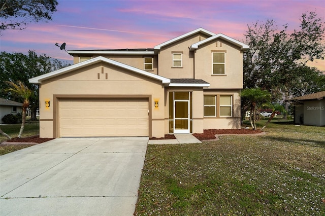 view of front property featuring a lawn and a garage