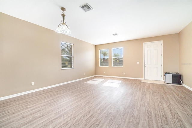 unfurnished room with light wood-type flooring