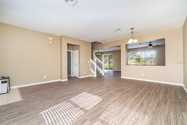 unfurnished living room with hardwood / wood-style flooring and ceiling fan