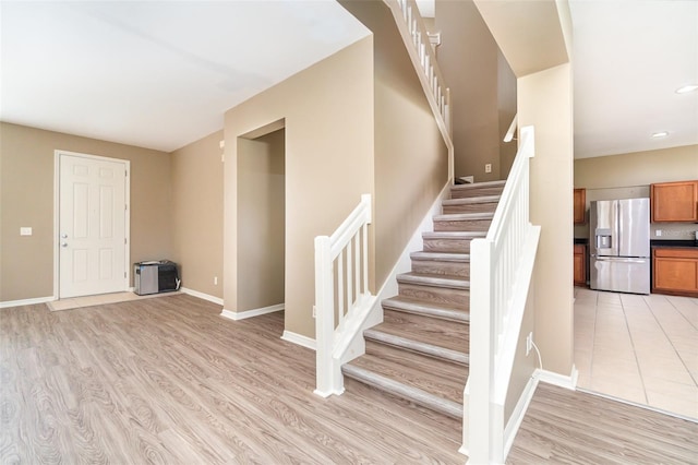 stairs featuring hardwood / wood-style flooring