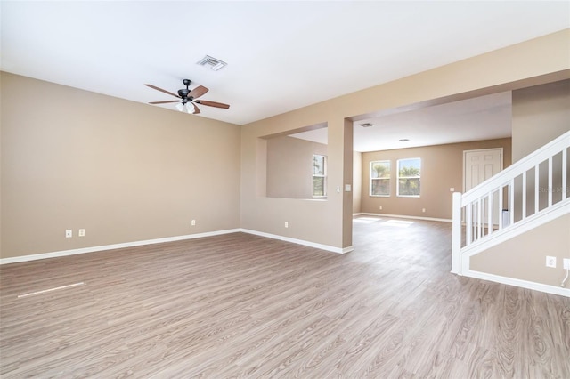 unfurnished living room featuring ceiling fan and light wood-type flooring