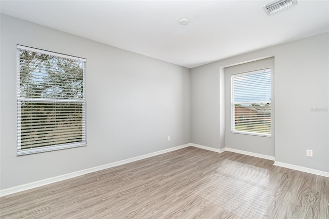 spare room with light hardwood / wood-style floors