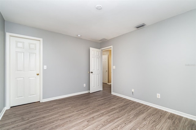 unfurnished room featuring wood-type flooring