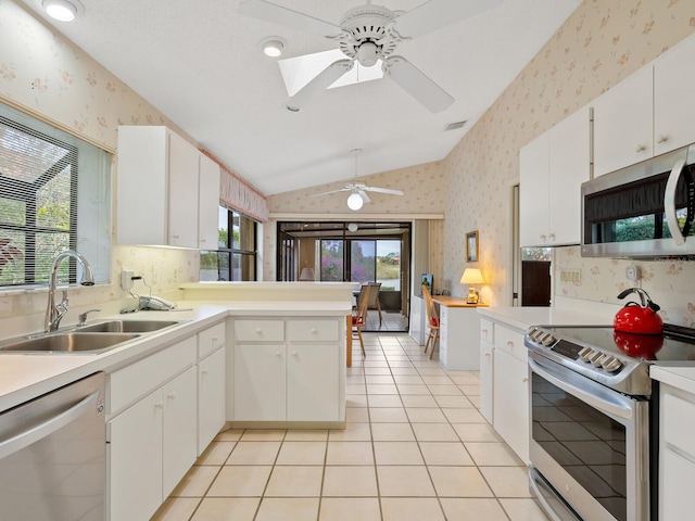 kitchen featuring white cabinets, kitchen peninsula, sink, and stainless steel appliances