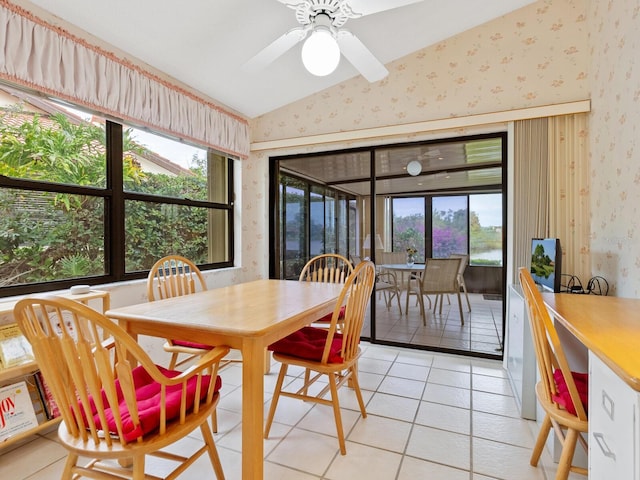 dining room with ceiling fan, light tile patterned flooring, and lofted ceiling