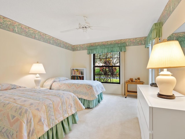 bedroom with light carpet and ceiling fan