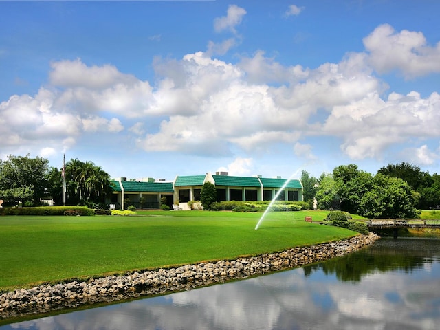 view of property's community with a yard and a water view