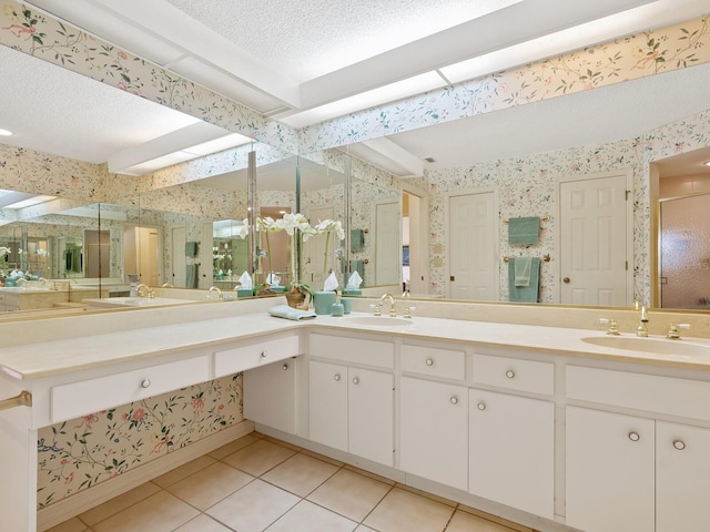 bathroom with vanity, tile patterned flooring, a textured ceiling, and a shower with door