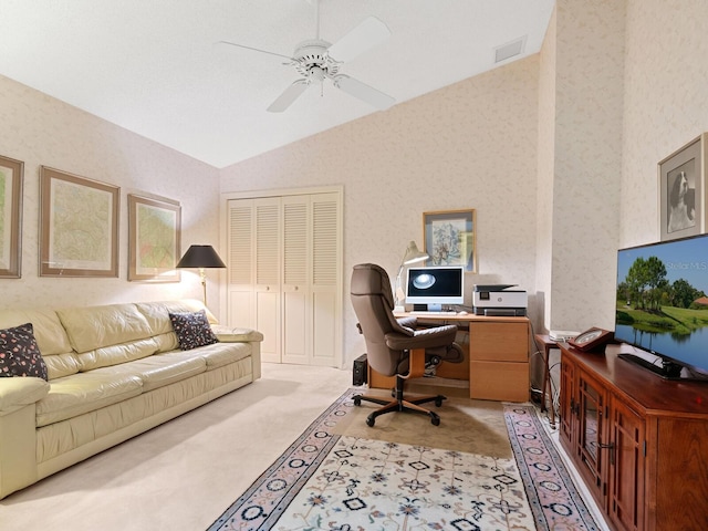 carpeted home office featuring vaulted ceiling and ceiling fan